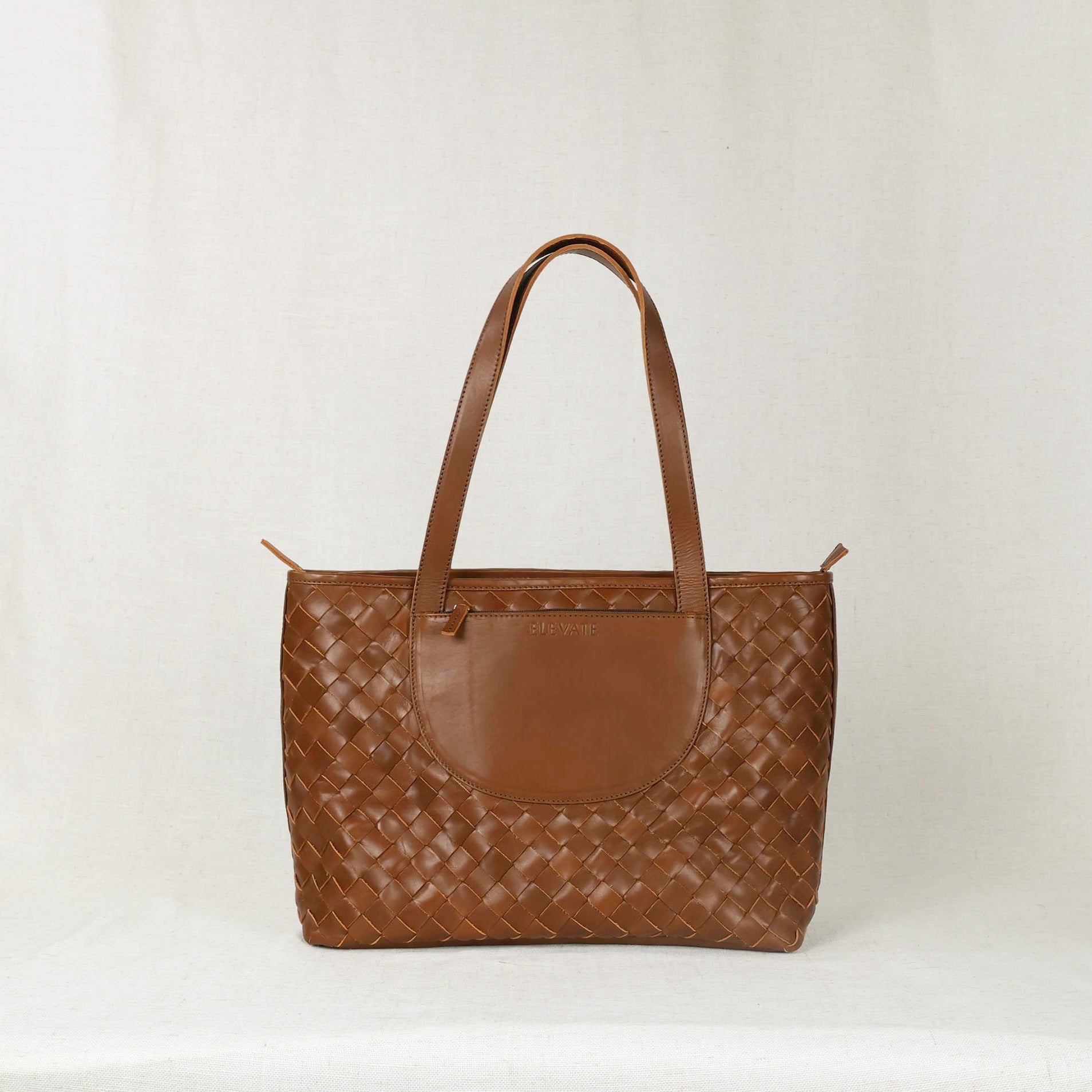 Interior view of the Woven Tara Tote – Hand Woven Leather Tote showing spacious compartments and built-in divider for laptops.